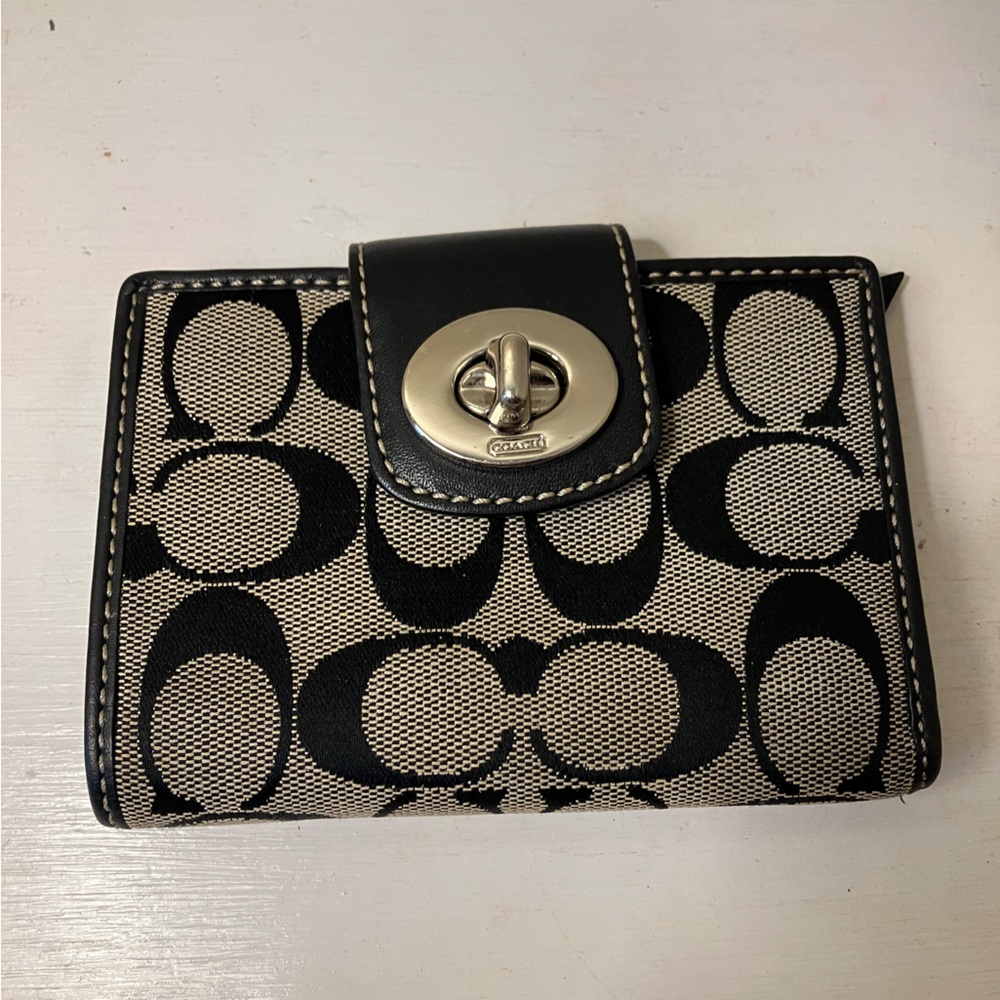 Leather Coach wallet with signature C pattern